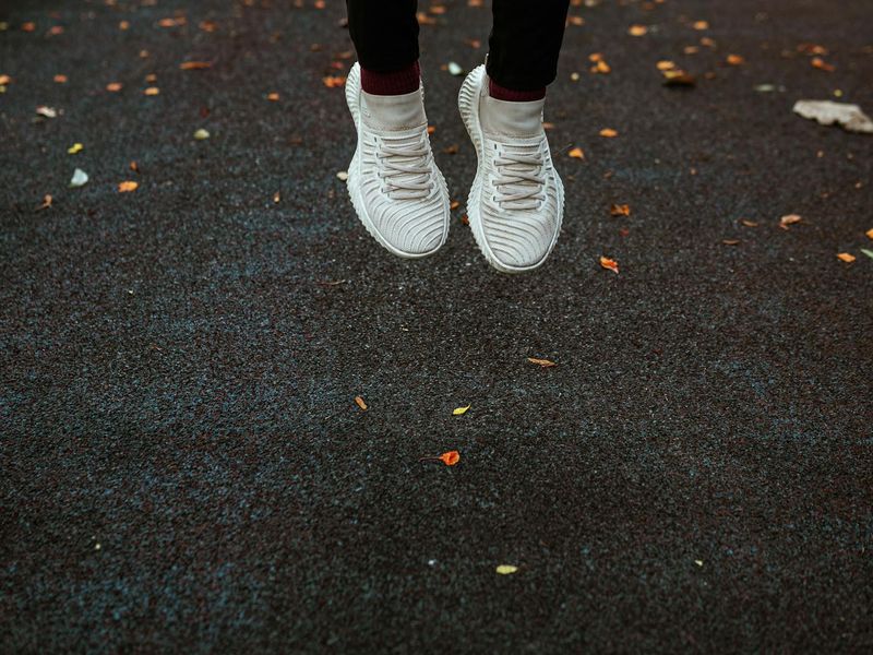 Athletic shoes jumping in a neon lit environment